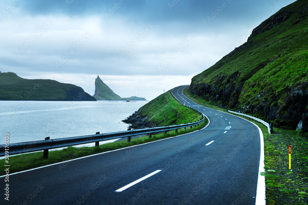 Dramatic evening view of the road and the Drangarnir and Tindholmur rocks in the background on the i