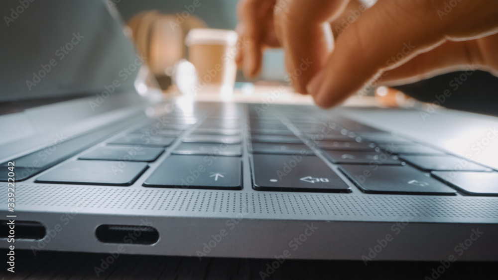 Close-up Moving Macro Shot: Person Typing on Laptop Keyboard. Working, Writing Emails, Using Interne