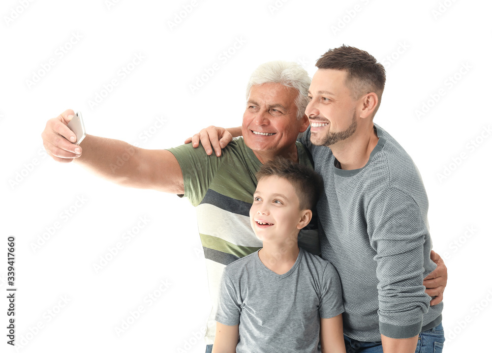 Man with his father and son taking selfie on white background