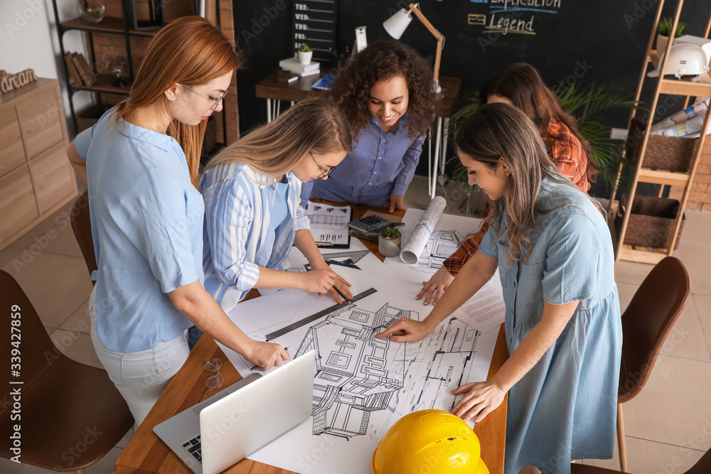 Architect teaching young people in office