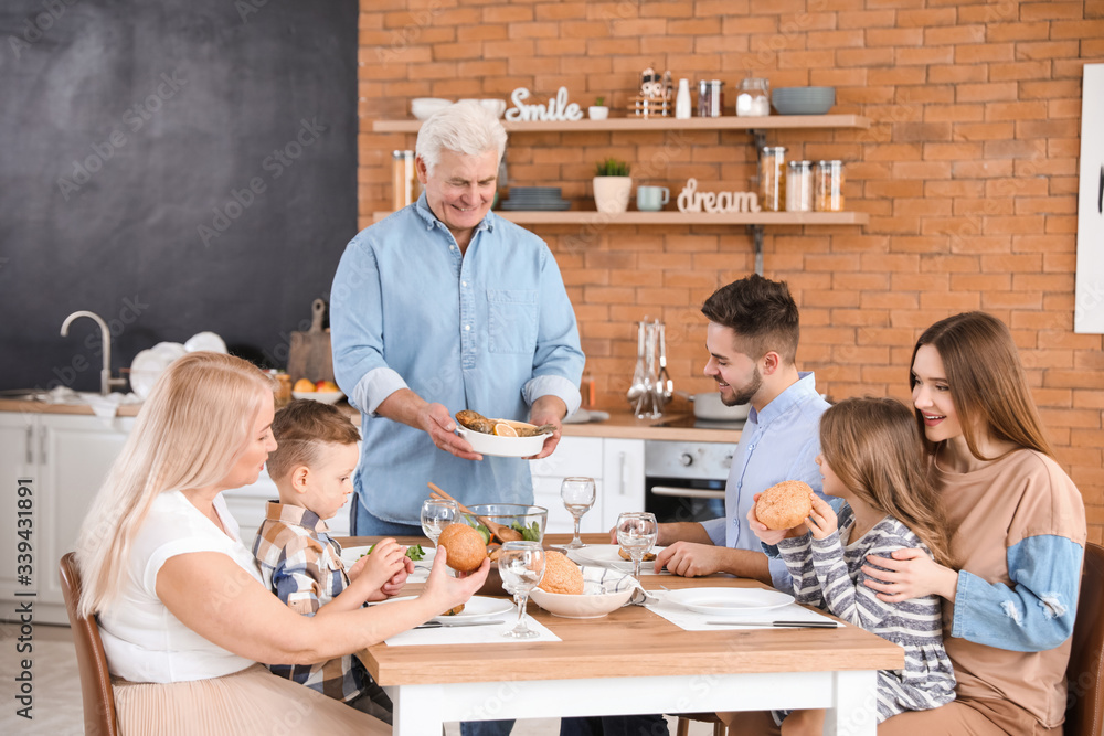 Big family having dinner together in kitchen