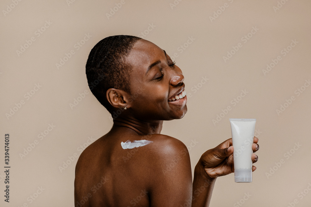 African woman holding cosmetics