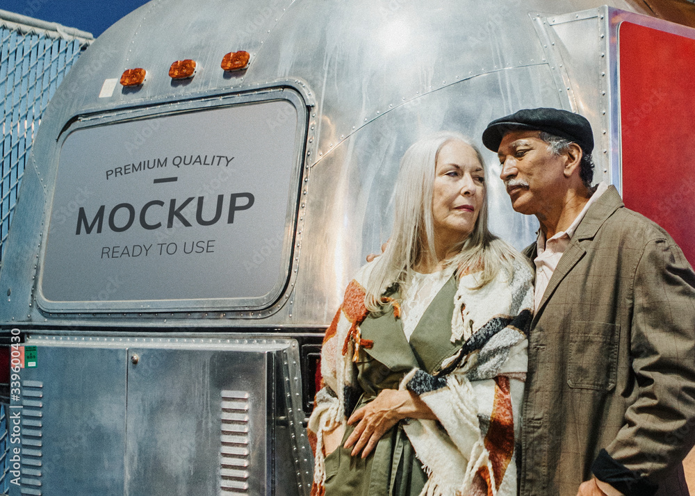 Senior couple standing by the food truck