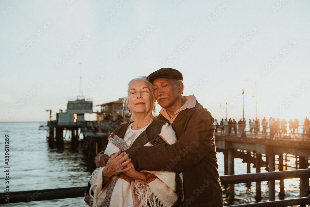 Senior couple intimately embracing by the sea