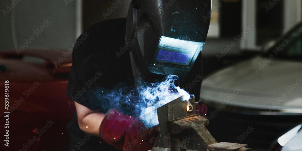 Woman welding metal