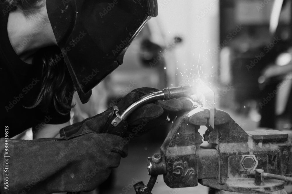 Woman welding metal