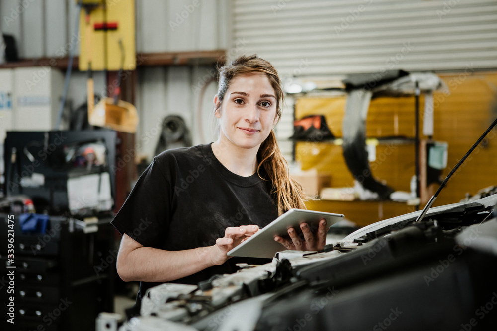 Happy female car mechanic