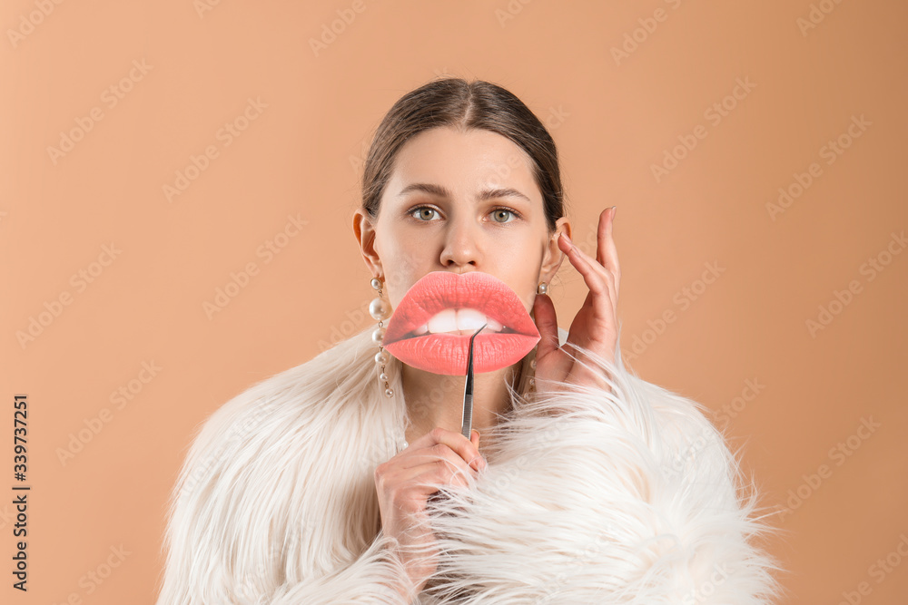 Young woman with paper lips on color background. Plastic surgery concept