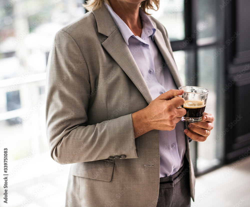 Woman standing with a cup of coffee