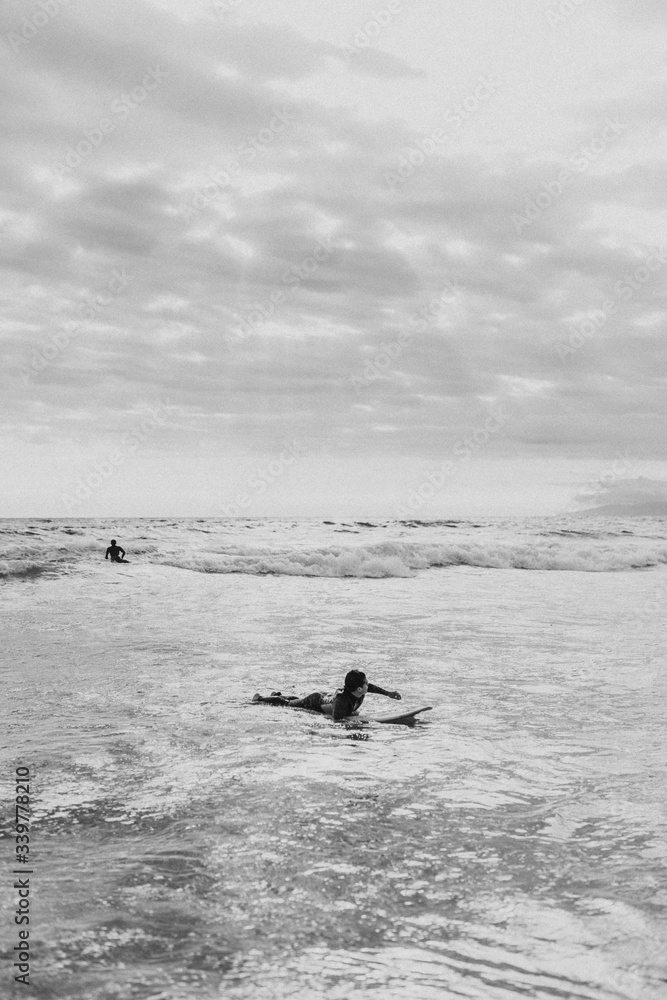 Surfer floating on the surfboard