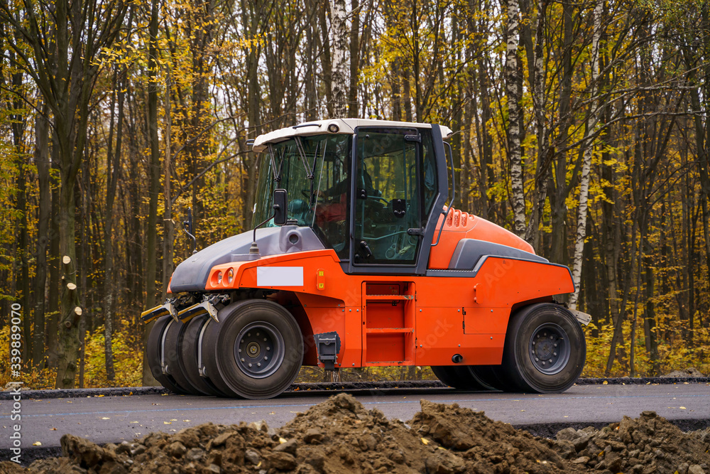 Pavement truck. Laying fresh asphalt on construction site. Heavy machine industry. Mechanical engine