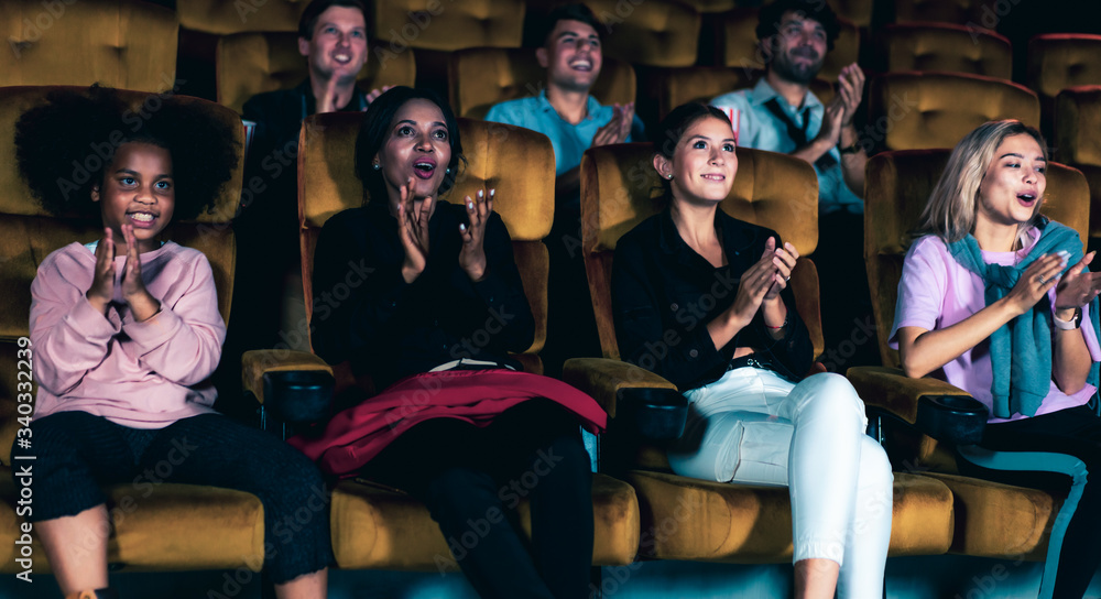 People audience watching movie in the movie theater cinema. Group recreation activity and entertainm