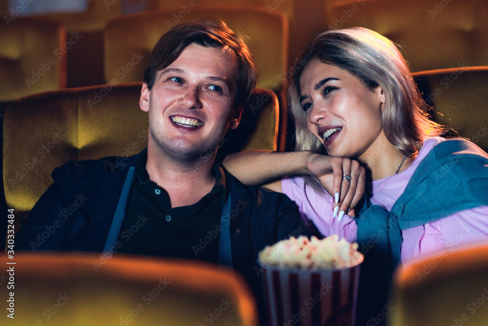 Caucasian lover enjoying to watch movie and eating popcorn together in the cinema