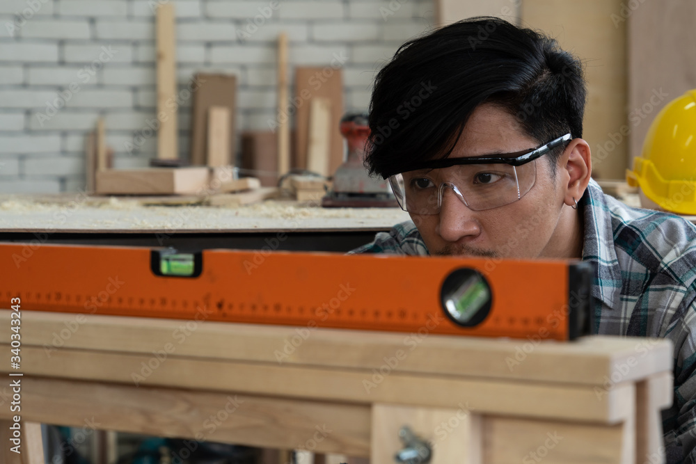 Carpenter working on wood craft at workshop to produce construction material or wooden furniture. Th