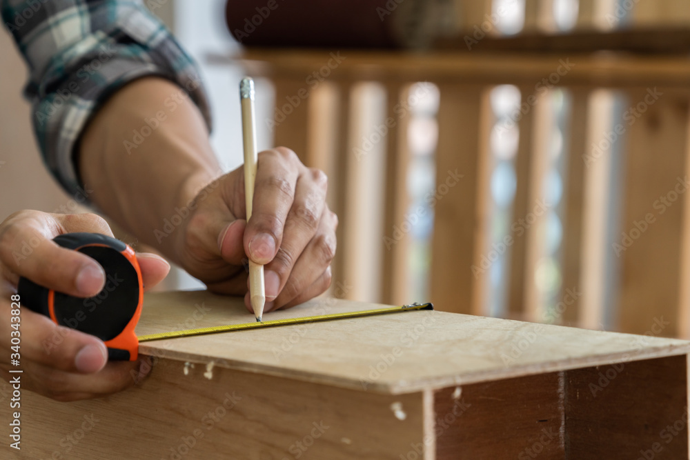 Carpenter working on wood craft at workshop to produce construction material or wooden furniture. Th