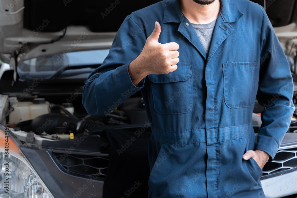 Professional mechanic providing car repair and maintenance service in auto garage. Car service busin