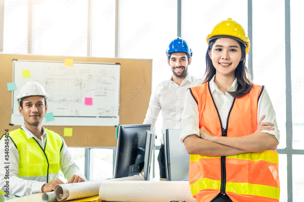 Asian young engineer group of home building member discuss for project planning. Smile woman standin