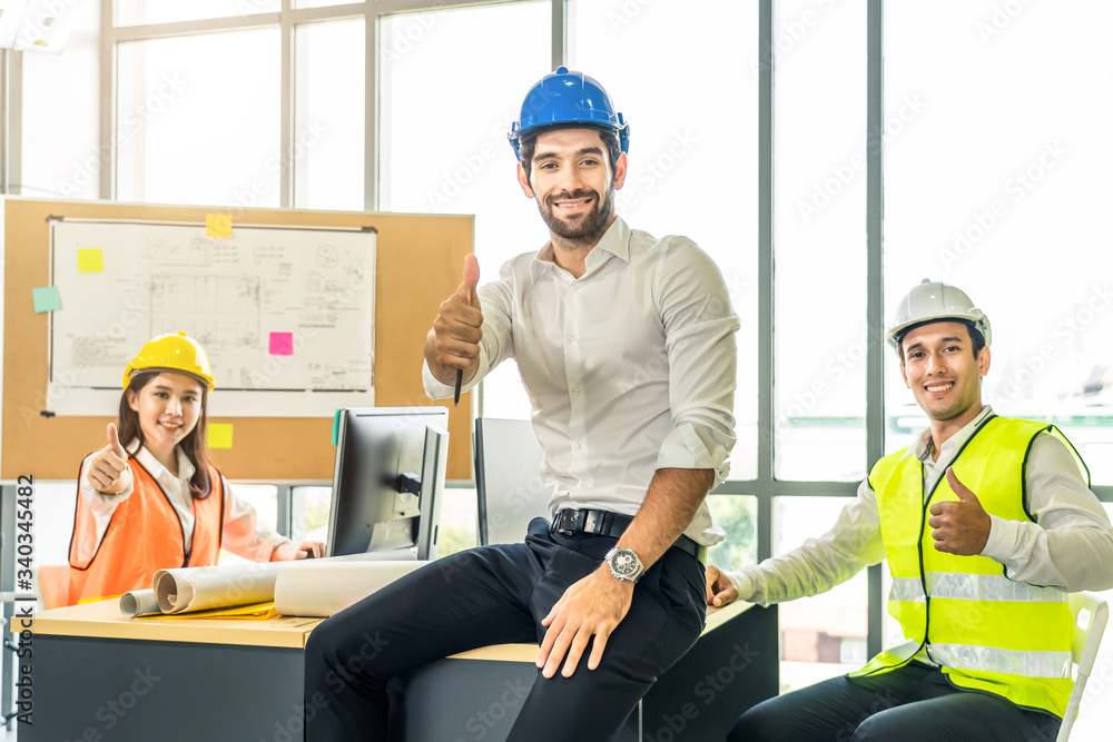 Asian young engineer group of home building member discuss for project planning. Smile man sitting s