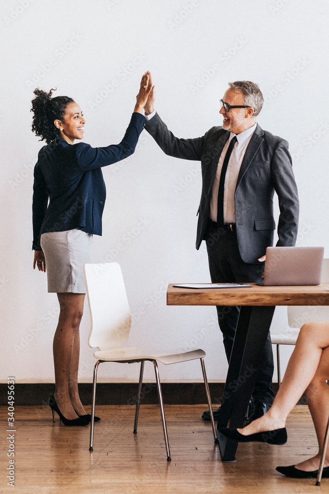 Successful businesspeople doing a high five