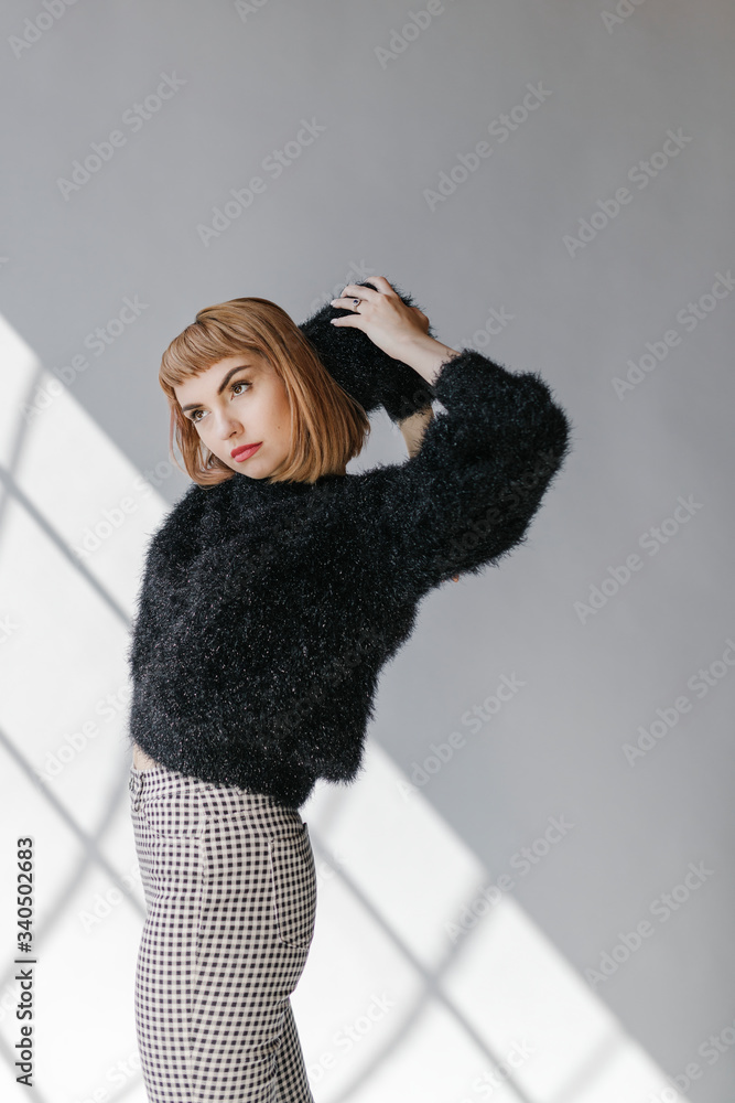 Model posing in a natural light studio