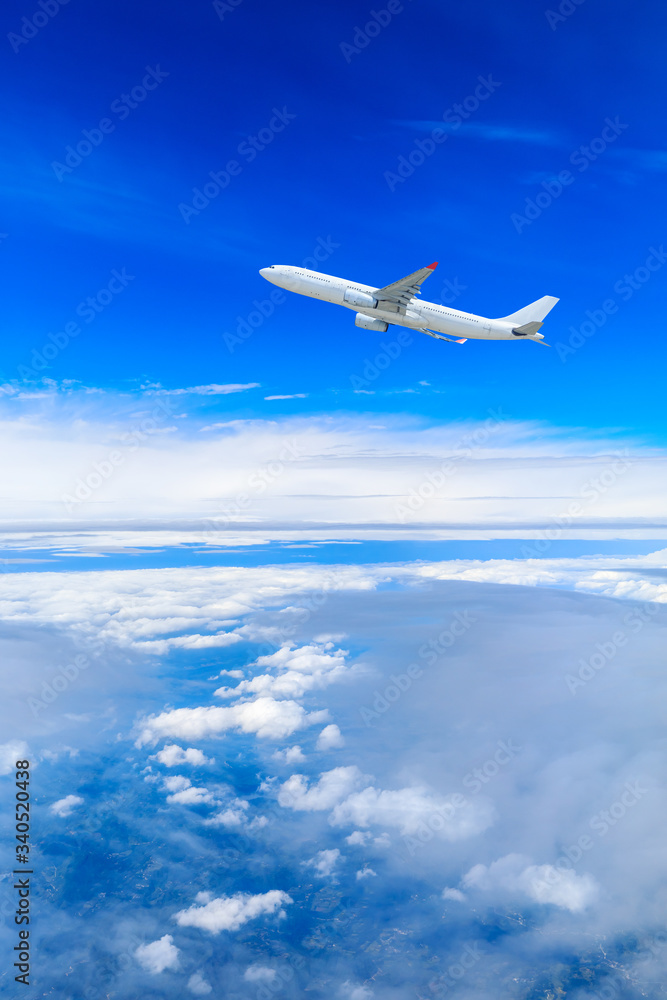 Commercial airplane flying above the clouds,travel concept.