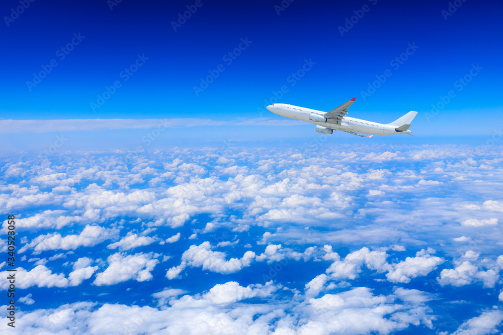 Commercial airplane flying above the clouds,travel concept.