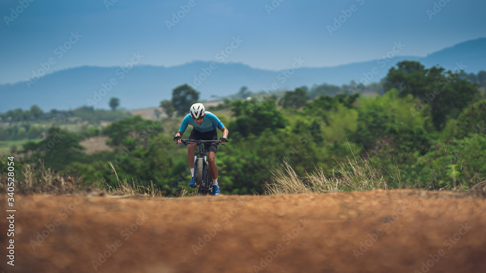 Mountain biker cyclist training on steep slopes