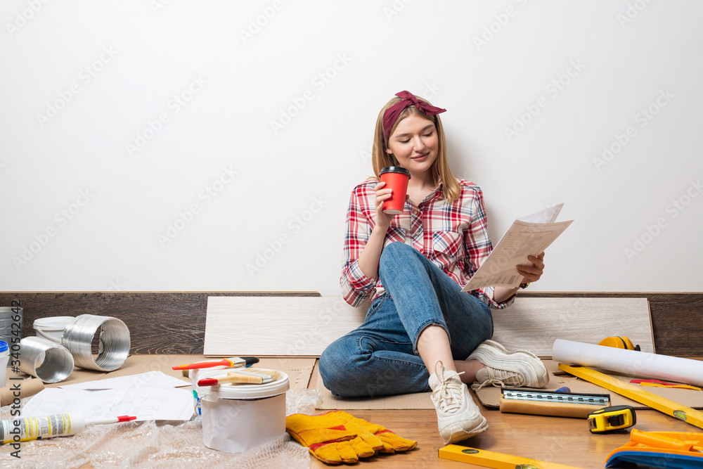 Beautiful girl sitting with paper blueprint