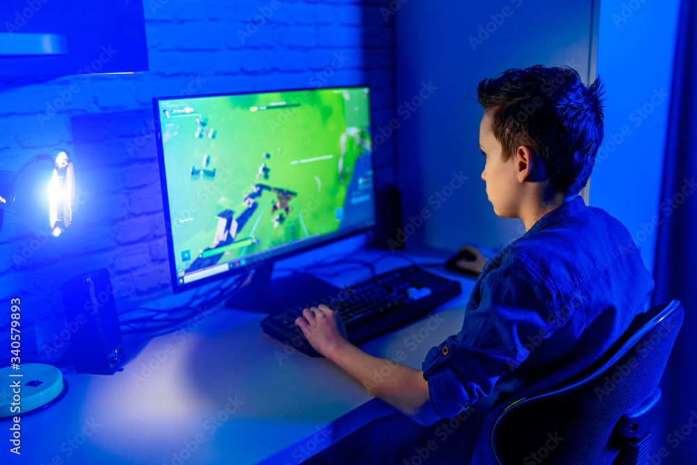 Teenage boy playes videogames. Addicted to video gaming at home