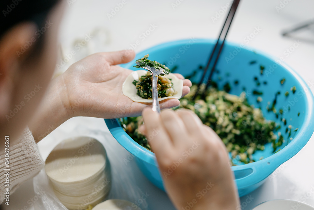 The cook is making dumplings in  kitchen