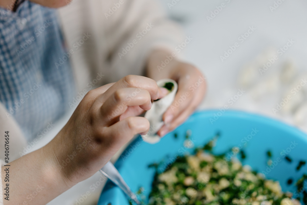 The cook is making dumplings in  kitchen