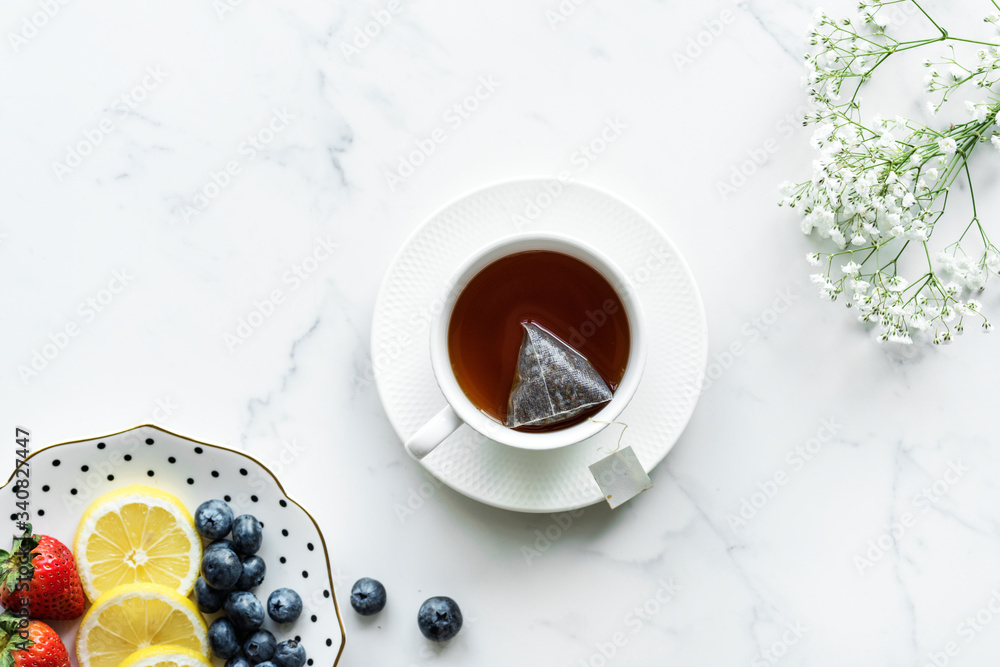 Aerial view of hot tea drink and fruits