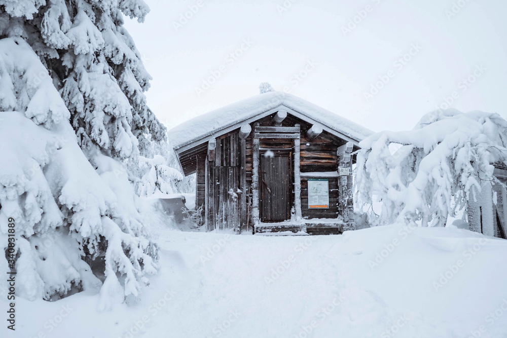 Wooden cabin in a snowy forest in Finland