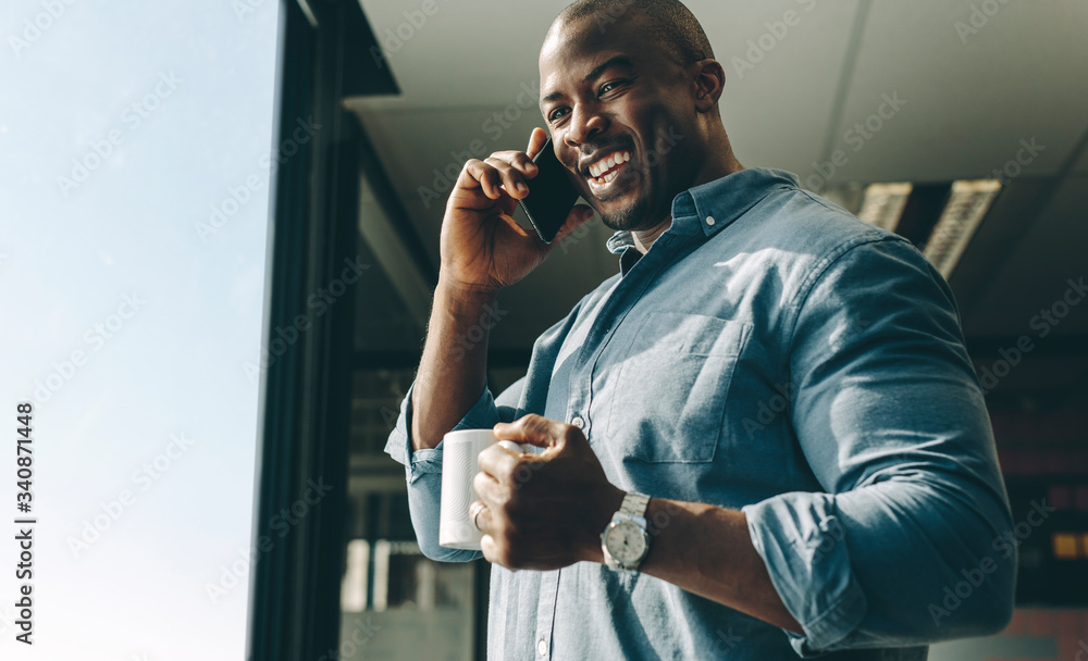 Smiling businessman talking on phone