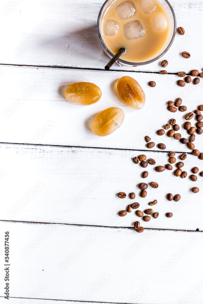 Ice coffee with milk for lunch on white wooden background top view