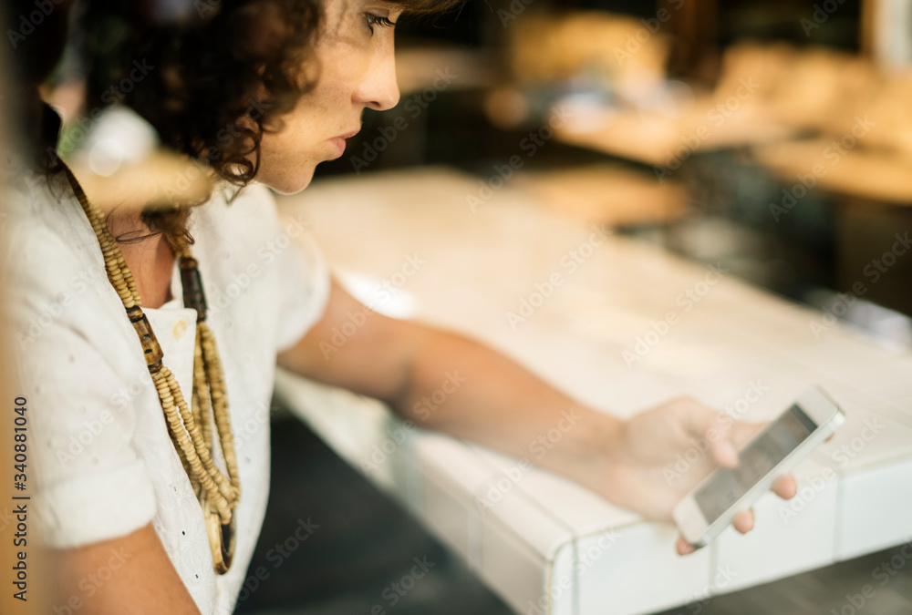 Businesswoman using mobile phone in coffee shop