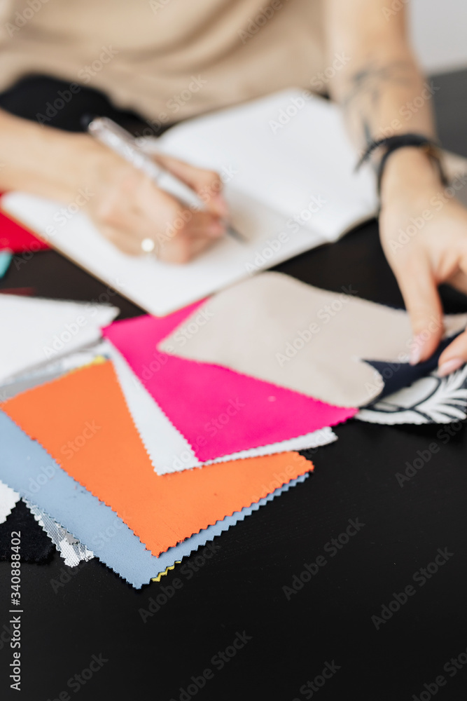 Designer with fabric samples