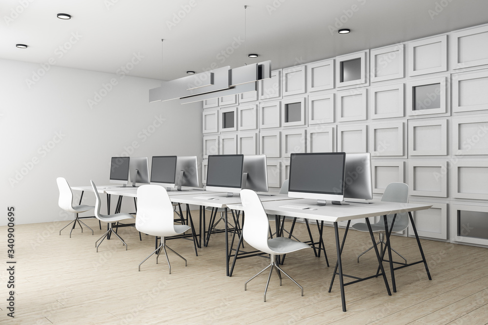 Contemporary blurry coworking office interior with equipment with computers on desktop