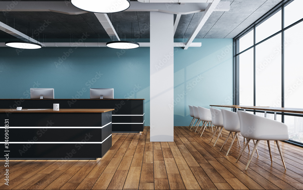 Luxury reception table with computers on loft interior with city view.