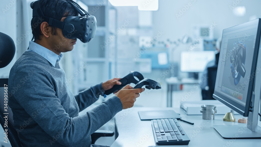 Modern Industrial Factory: Mechanical Engineer Wearing Virtual Reality Headset, Holding Controllers,