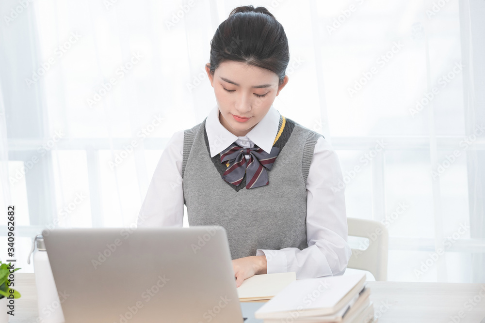 Asian female students taking classes on the Internet