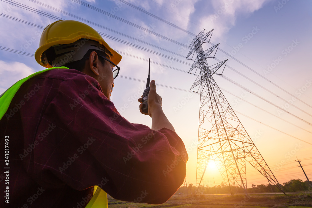 Asian Manager Engineering in standard safety uniform working inspect the electricity high voltage po