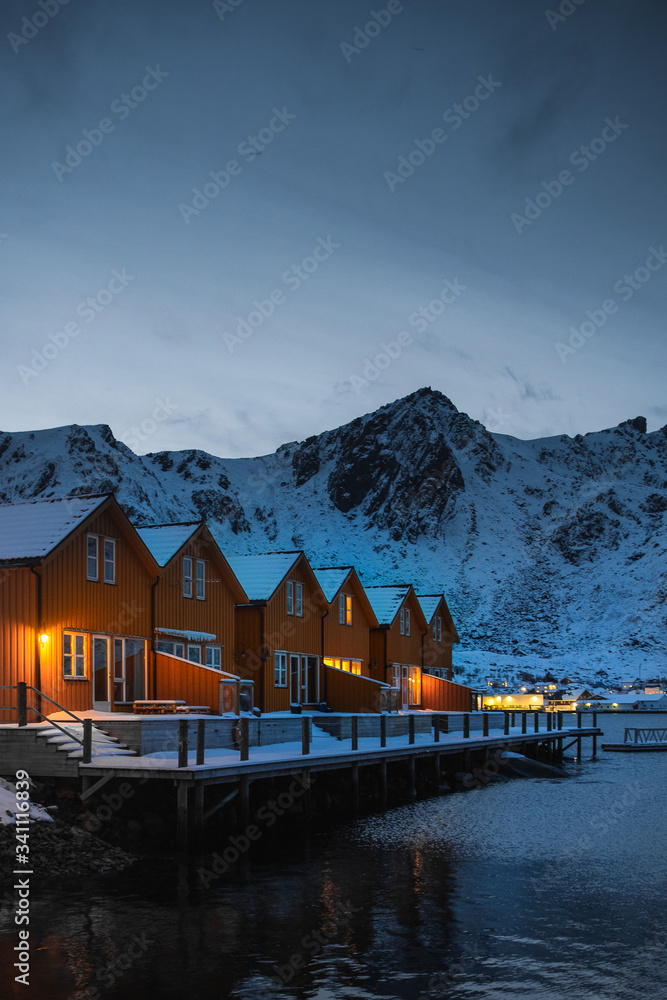 Orange cabins by the lake in Ballstad village, Norway