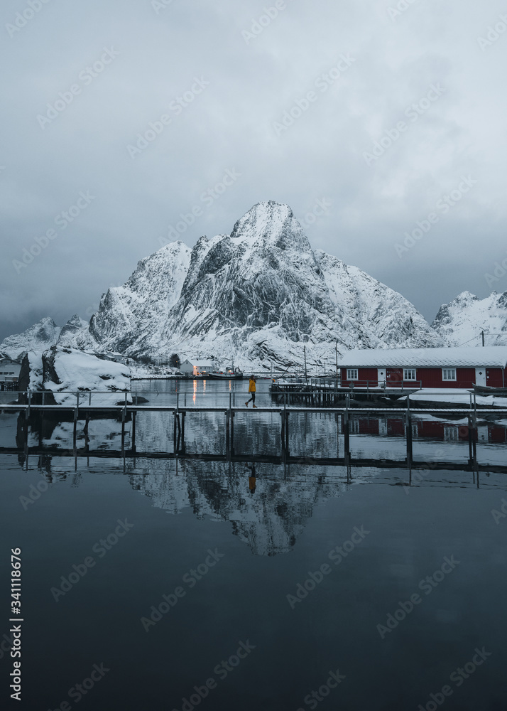 Red cabins on a snowy Reine in Moskenesøya island, Norway