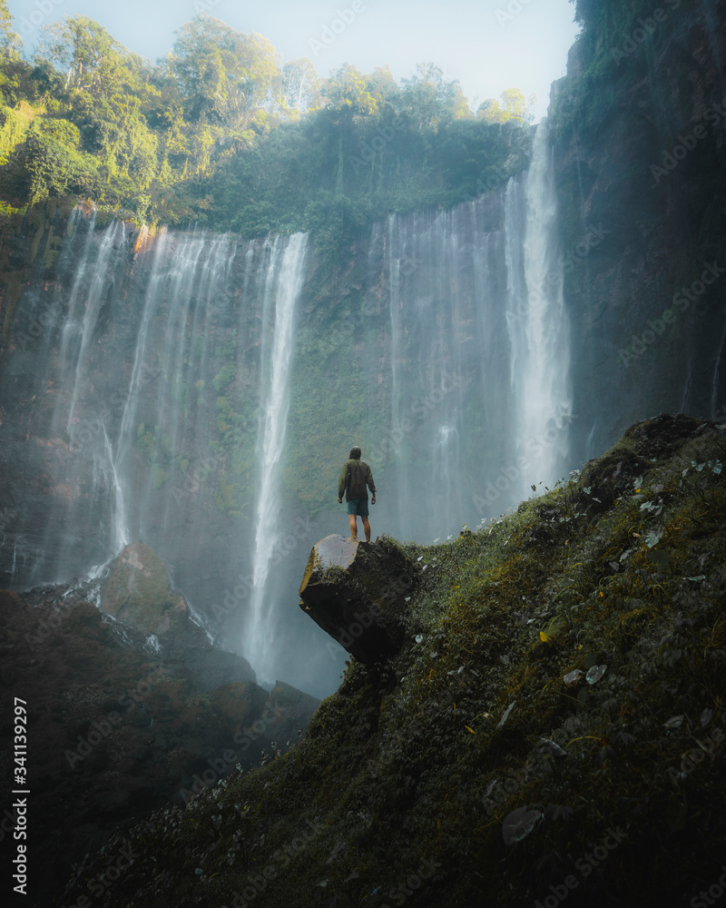 Man standing by Tumpak Sewu Waterfalls