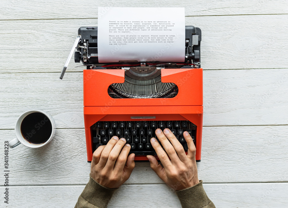 Aerial view of a man typing on a retro typewriter