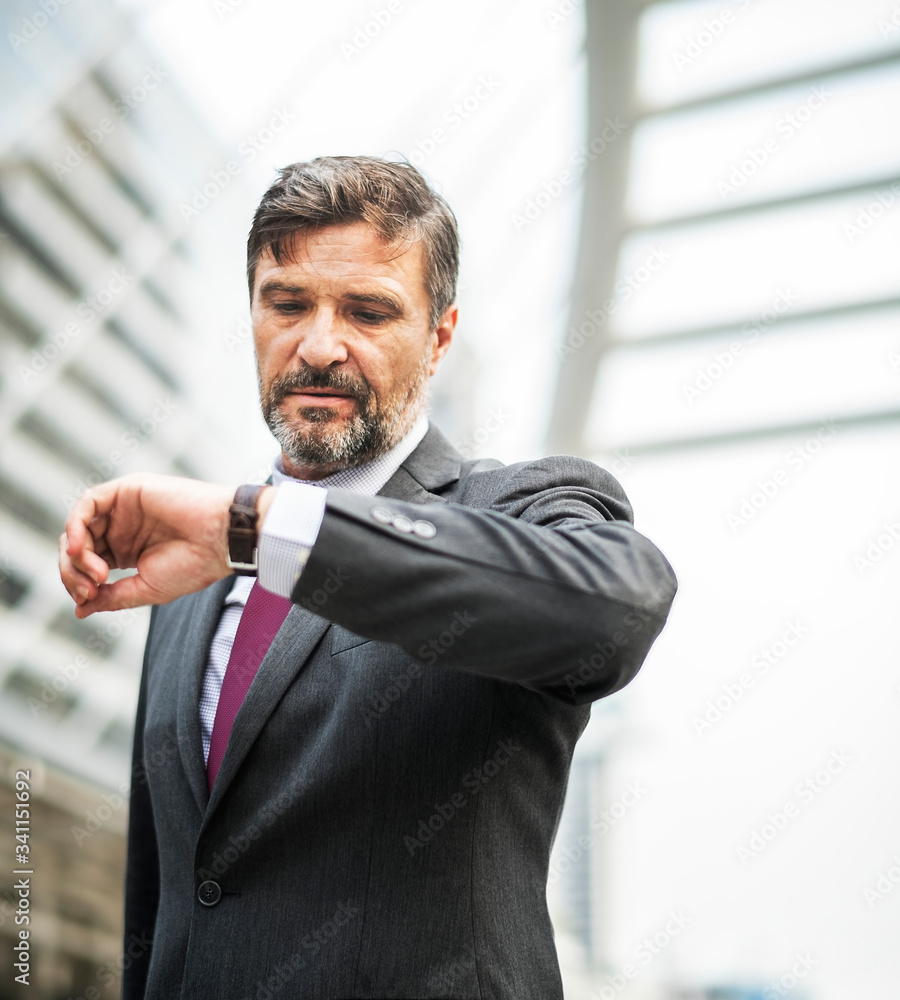 Busy businessman checking his watch