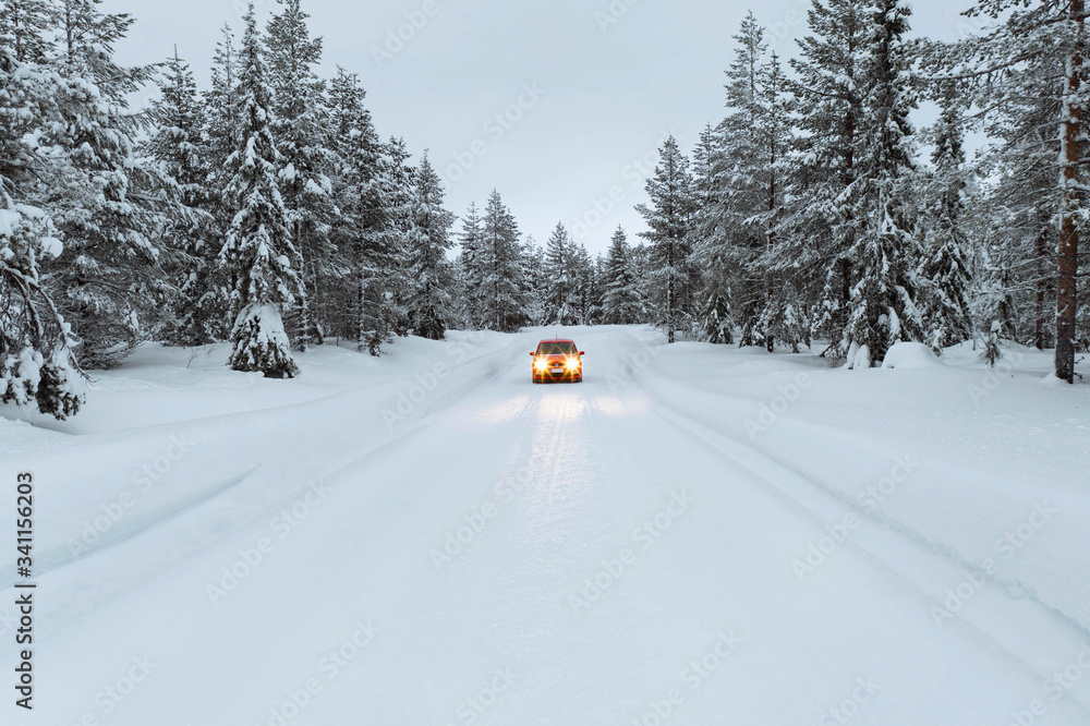 Red car in snowy forest