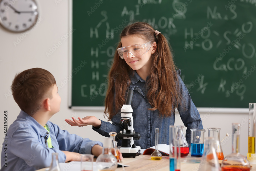 Cute little children at chemistry lesson in classroom