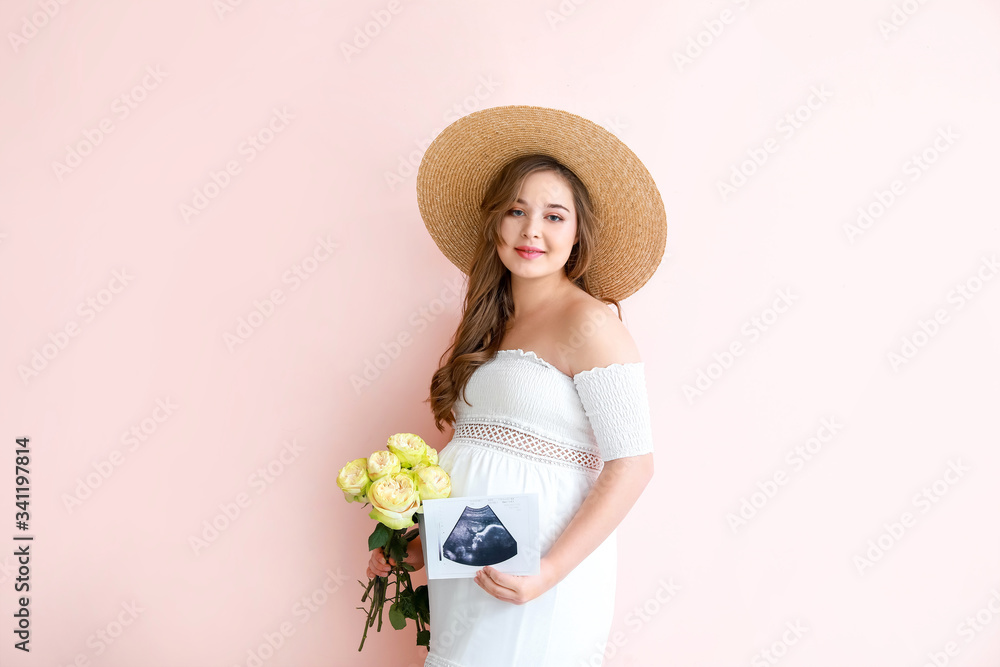 Beautiful pregnant woman with flowers and sonogram image on color background